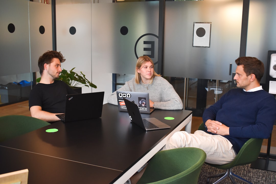 business meeting agency - woman in gray sweater sitting on green chair